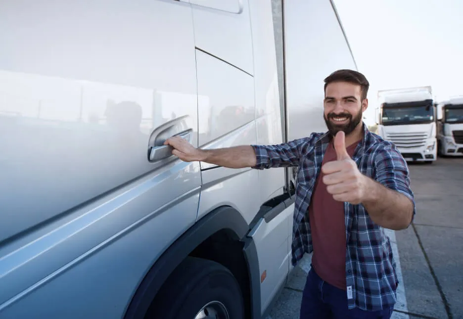 professional-middle-aged-bearded-trucker-standing-by-his-semi-truck-holding-thumbs-up